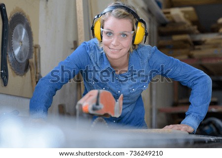 young woman carpenter working in her workshop