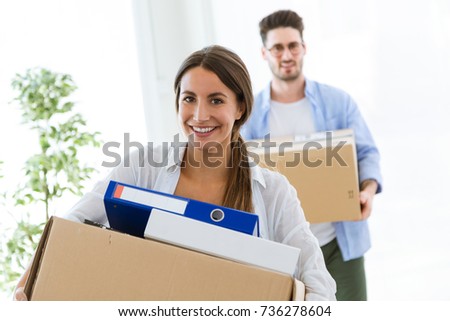 Portrait of beautiful young couple moving at new home.