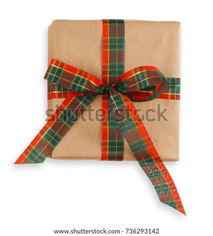 Gift box wrapped in craft brown paper and checkered ribbon, isolated on white background. Modern present for any holiday, christmas, valentine or birthday