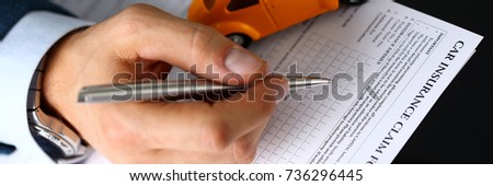 Male arm in suit filling insurance form lying on table with silver pen closeup. Strike a bargain, driver money loss prevention, secure road trip, harmless drive idea, owner protective offer concept