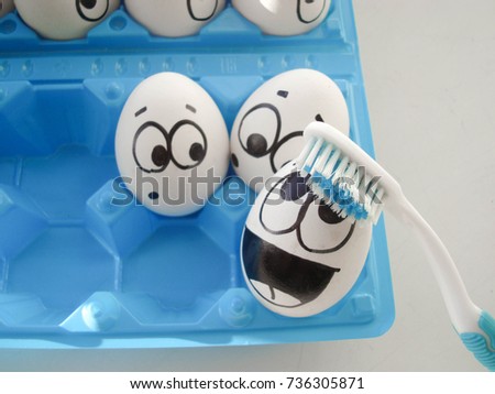 caries concept. funny eggs in the container. toothbrush