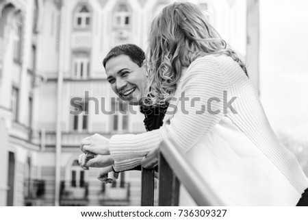 A cheerful and positive couple man and woman are walking in the city, relaxing and enjoying time with each other. The concept of feelings and love in middle-aged people