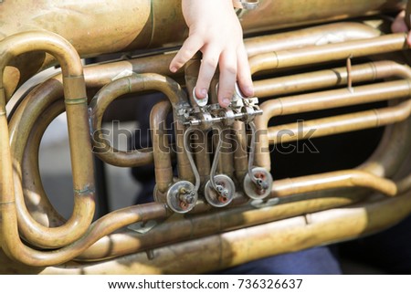 children's hands playing musical instruments