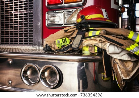 Firemen gear on firetruck Royalty-Free Stock Photo #736354396