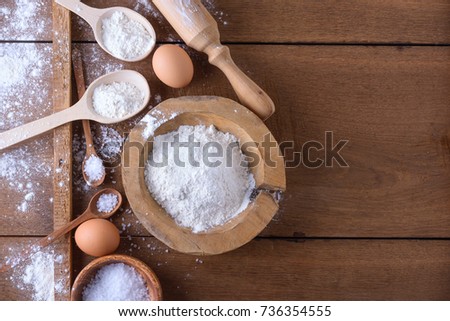 Baking ingredients for recipe book, eggs, rolling pin on wooden table