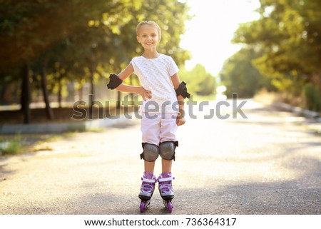 Cute girl rollerskating in park