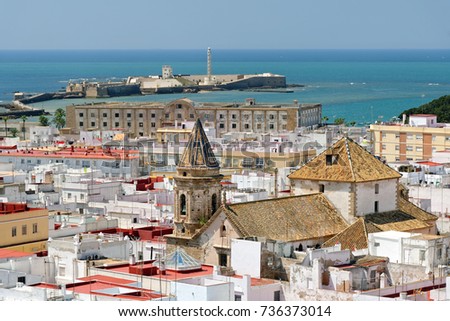 Aerial view of Cadiz from Torre Tavira with San Sebastian castle in, Spain, an ancient port city, built on a strip of land surrounded by the sea with more than 100 watchtowers, used for spotting ships
