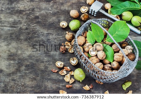 Whole Walnuts and Cleared in the basket Black Wooden Background Top view Healthy concept.