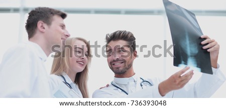 Healthcare, medical and radiology concept - doctors looking at x-ray