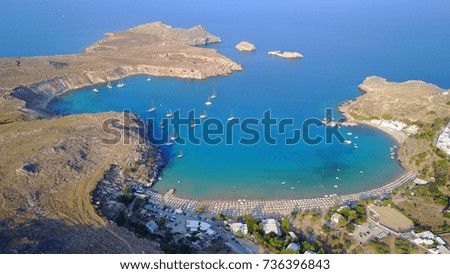Aerial birds eye view photo taken by drone of iconic beaches in village of Lindos, Rhodes island, Dodecanese, Greece