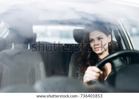 Young beautiful girl driving a car