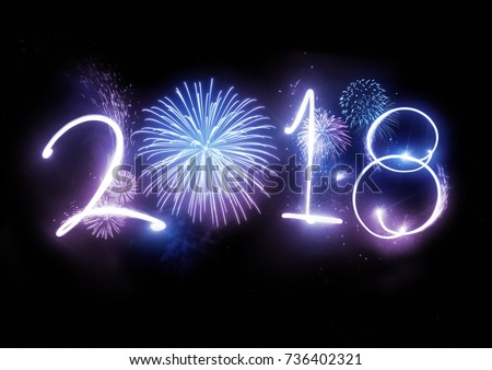 The year 2018 displayed with fireworks and strobes. New year and holidays concept. Royalty-Free Stock Photo #736402321