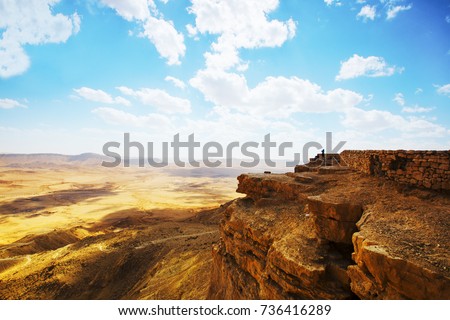 The bottom of Ramon Crater (Makhtesh Ramon), the largest in the world, as seen from the high rocky cliff edge surrounding it from the north, Ramon Nature reserve, Mitzpe Ramon, Negev desert, Israel