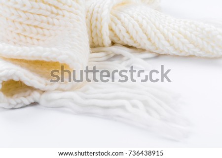 soft warm white knitted hat, scarf and gloves for cold autumn and winter weather on a white background