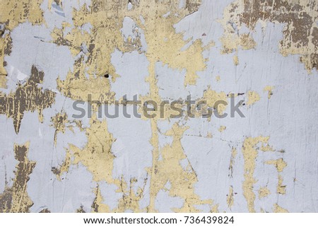 Ragged textured paint cover on a crumbling of the old stucco wall