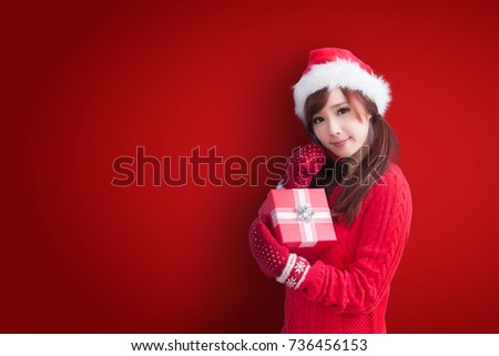 beauty woman take gift and smile to you with christmas on red background