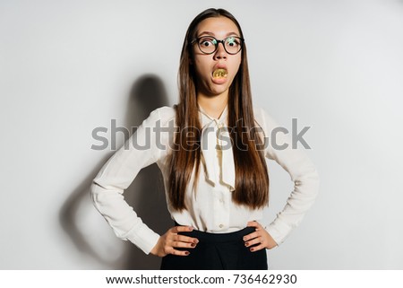 a mad girl with long hair and wearing glasses put a coin in her mouth. bitcoins, crypto currency, isolated