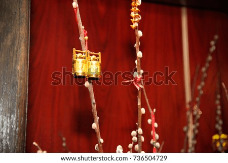 chinese gold good luck charm ornament on a branch