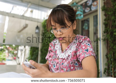 Asian woman checking her mails on smart phone