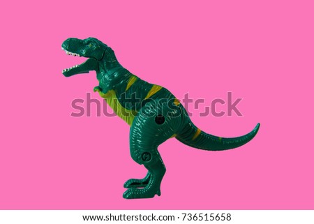 Green Dinosaur, Plastic Toy Animal isolated on pink background.