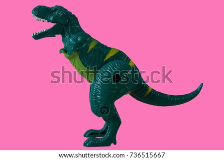 Green Dinosaur, Plastic Toy Animal isolated on pink background.