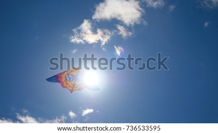 Kites in the sky. Colorful kites flying in blue sky. Under the blue sky flying kites