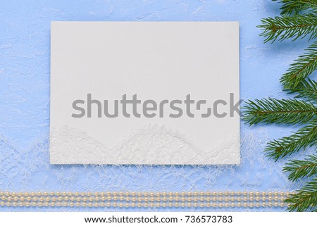 Christmas flat lay Primed cardboard for painting on the background of decorative plaster, fir branches and beads