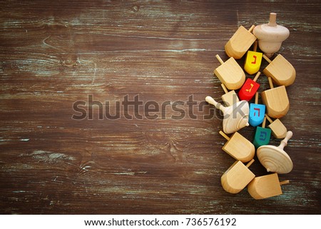 Image of jewish holiday Hanukkah with wooden dreidels colection (spinning top) on the table.