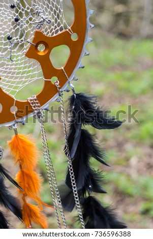 black and orange Dreamcatcher with star made of feathers leather beads and ropes, hanging