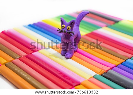 Play clay abstraction. Cat on colored background.
