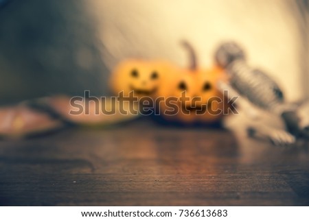 Halloween pumpkin head jack lantern with skeleton on woodend background. copy space