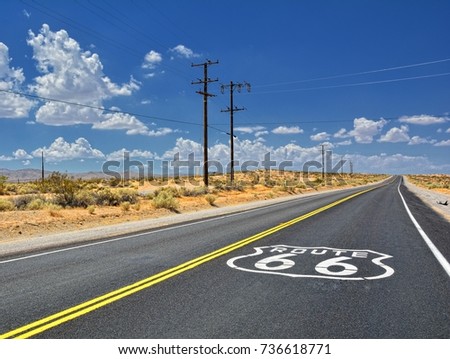 U.S. Route 66 highway, with sign on asphalt on California.  Royalty-Free Stock Photo #736618771