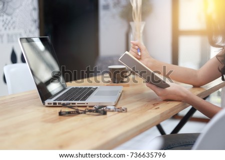Business Young woman wearing smartwatch using laptop computer. Female working on laptop in cafe.  woman working concept