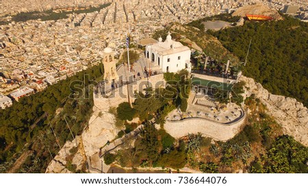 Aerial birds eye view photo taken by drone of iconic Saint George chapel in Lycabettus hill, Athens historic center, Attica, Greece