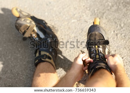 Legs of roller skater, outdoors