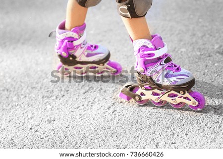 Child rollerskating in park