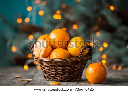 christmas concept with Tangerines, Fir , lights ,Snow, boke and snowflakes, on wooden background