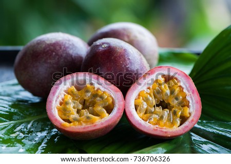 Passion fruit whole and slise on a natural background. Tropical fruits. The Fruit of Passion. Maracuya Royalty-Free Stock Photo #736706326