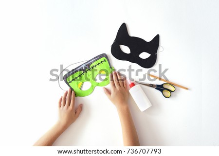 Making of masks from paper for the holiday Halloween from paper.  Royalty-Free Stock Photo #736707793