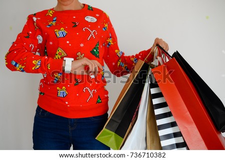 Christmas time and happy busy woman holding shopping bags on light background. Closeup image of person having fun enjoying getting ready for happiness and delight luxury lifestyle.