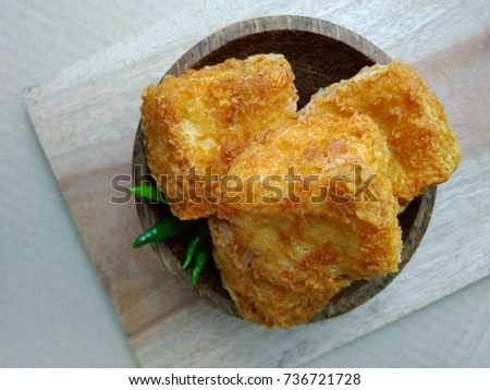 Flat Lays or top view, tahu sumedang (Fried Tofu) from west java,  indonesia with green hot chili at Wooden small bowl
