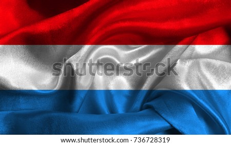 Realistic flag of Luxembourg on the wavy surface of fabric. This flag can be used in design.