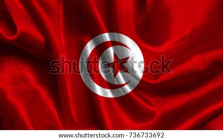 Realistic flag of Tunisia on the wavy surface of fabric. This flag can be used in design.