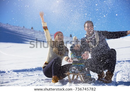 the happy family rides the sledge in the winter wood, cheerful winter entertainments
