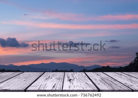 Empty top of wooden table and view of sunset or sunrise background. For product display