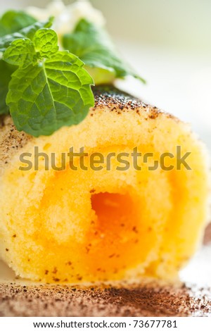 Biscuit roll with cream and mint as outdoor photo