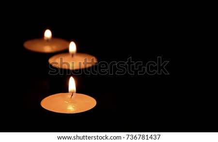 Light candles in the dark with spaces for text.