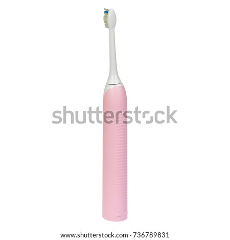 Pink electronic ultrasonic toothbrush on a charge stand isolated on a white background. Back side