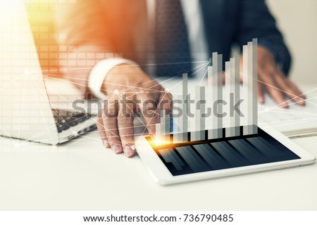 businessman hand working with new modern computer, smartphone and business strategy as concept. Royalty-Free Stock Photo #736790485