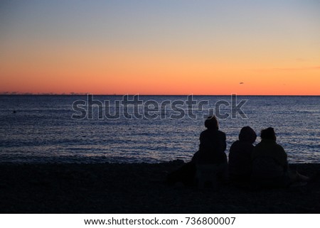 Silhouette of people over Black sea seaside in Sochi at the summer sunset time, Russian Federation. Selected Focus.